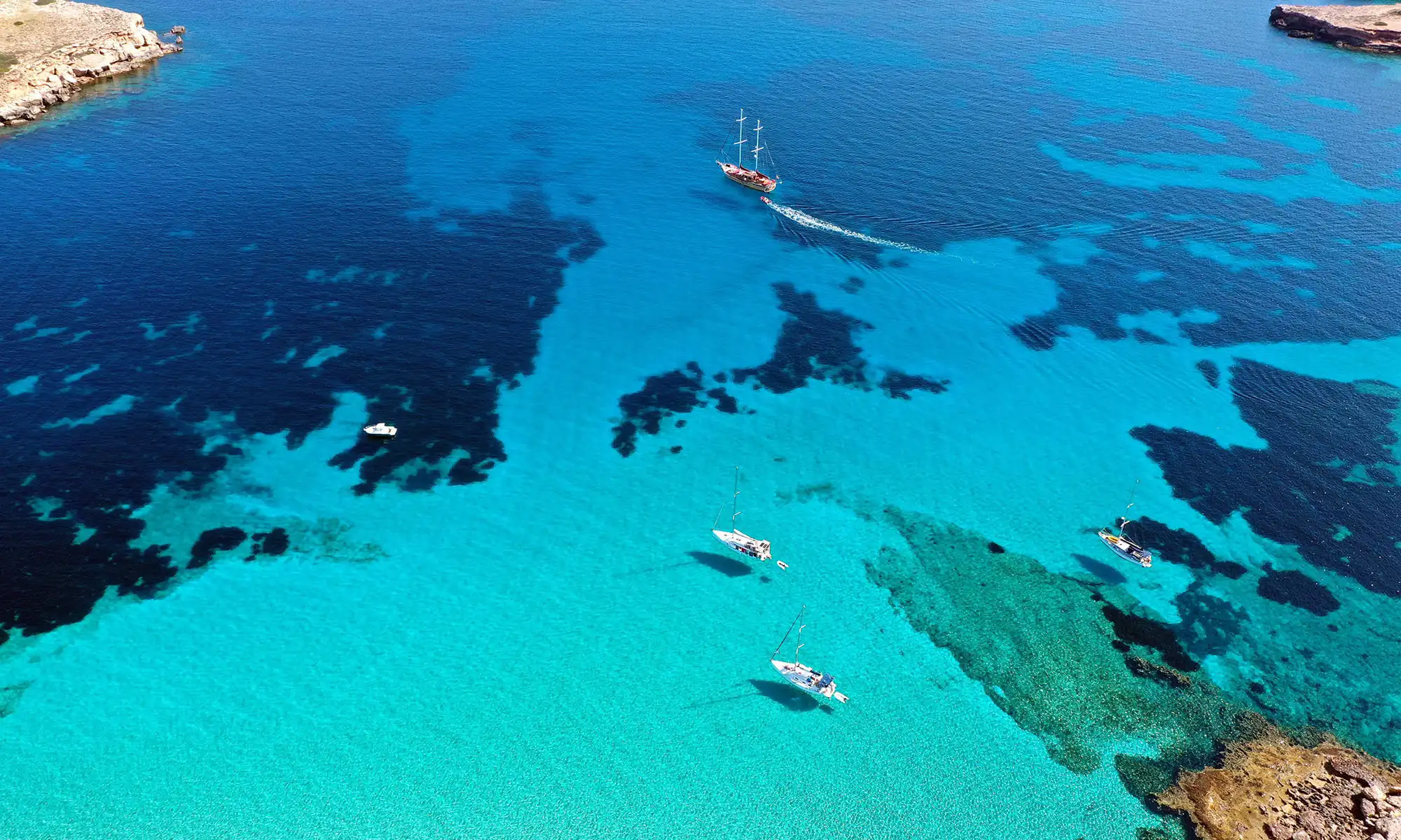 Turquoise Red Sea reef and excursion boats near Hurghada