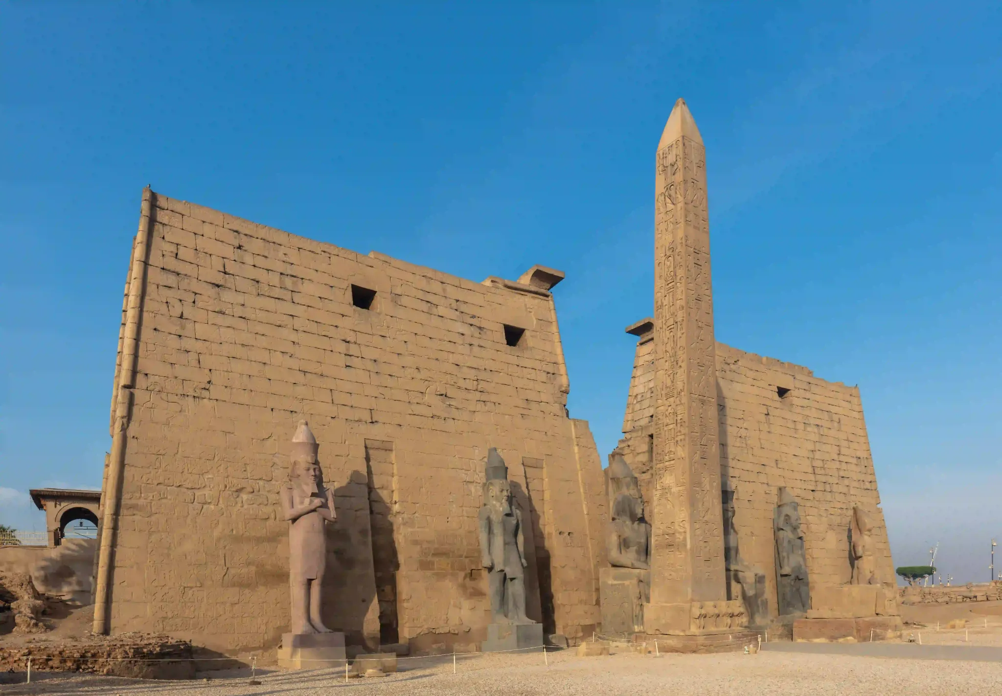 Luxor Temple and ancient obelisk beneath a clear blue sky