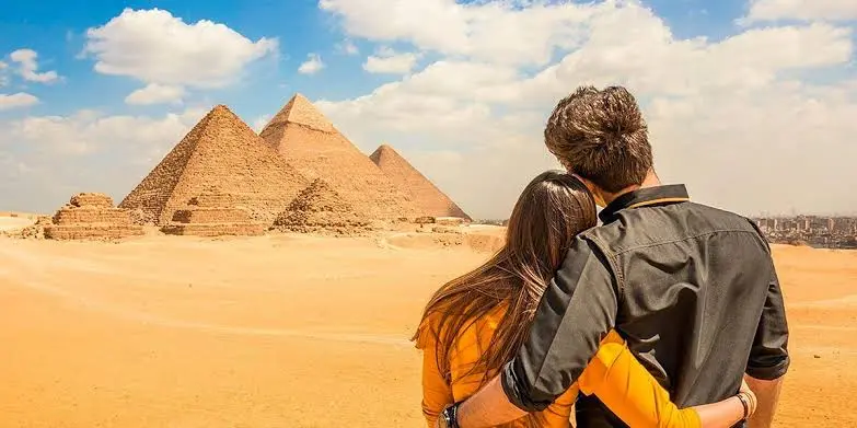 Couple overlooking the Giza Pyramids during a 12-day Egypt package