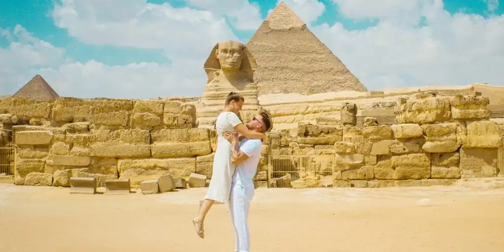 Honeymoon couple posing beside the Great Sphinx in Giza
