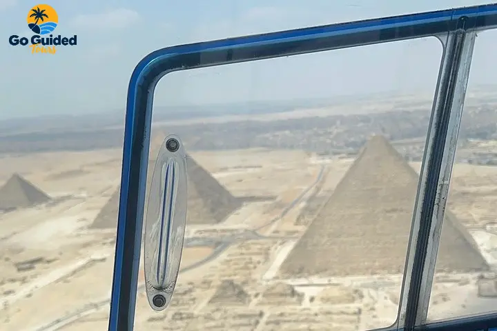Aerial view of the Giza Pyramids from a helicopter window